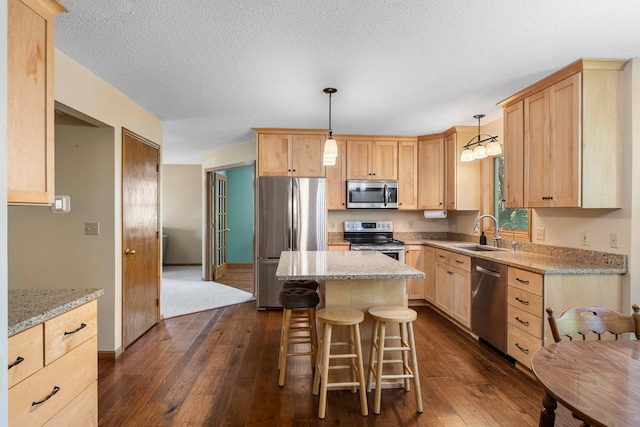 621 Twelve Oaks Ln, Hudson, WI 54016 - kitchen with appliances with stainless steel finishes, light brown cabinets, dark wood-type flooring, and a textured ceiling