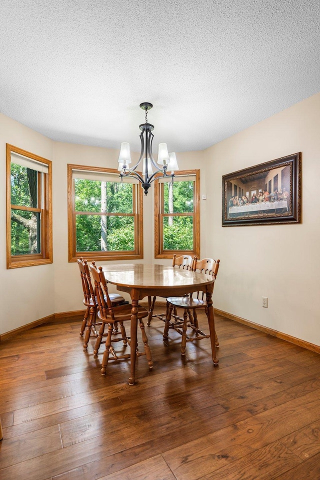621 Twelve Oaks Ln, Hudson, WI 54016 - dining space with a chandelier, a textured ceiling, and hardwood / wood-style floors