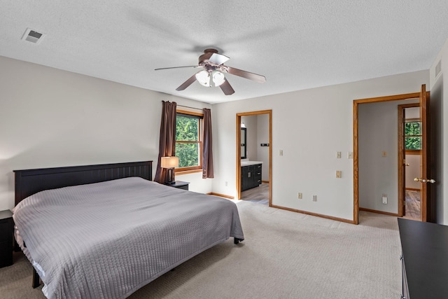 621 Twelve Oaks Ln, Hudson, WI 54016 - bedroom with light colored carpet, ceiling fan, ensuite bathroom, and a textured ceiling