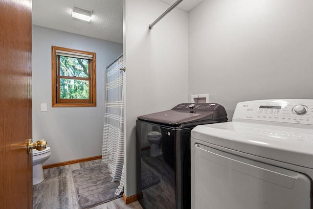 621 Twelve Oaks Ln, Hudson, WI 54016 - laundry room with washing machine and dryer and light wood finished floors