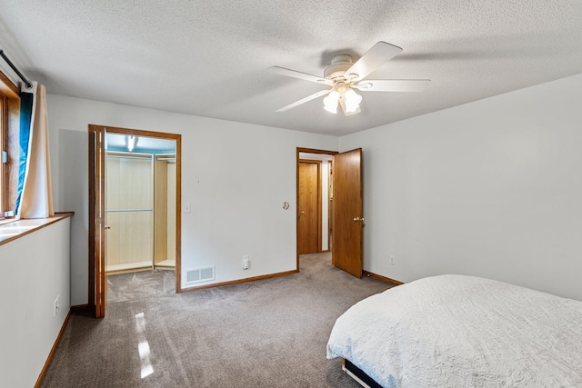 621 Twelve Oaks Ln, Hudson, WI 54016 - bedroom with carpet floors, a textured ceiling, a ceiling fan, and a spacious closet