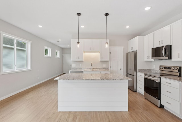 2728 229th Ln NW, Saint Francis, MN 55070 - kitchen featuring stainless steel appliances, a kitchen island, light wood-style floors, white cabinets, and recessed lighting