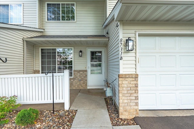 8731 Quarry Ridge Ln Unit B, Woodbury, MN 55125 - property entrance with brick siding and a garage