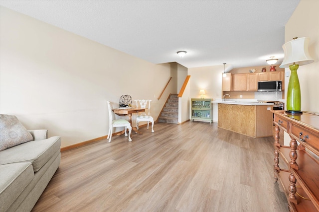 8731 Quarry Ridge Ln Unit B, Woodbury, MN 55125 - living room featuring light wood-style flooring and stairway
