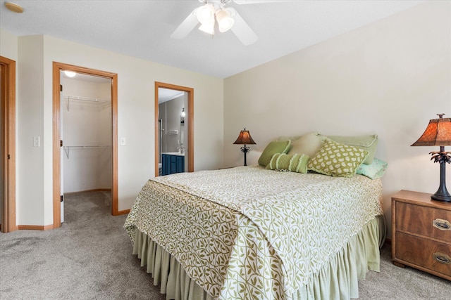 8731 Quarry Ridge Ln Unit B, Woodbury, MN 55125 - carpeted bedroom featuring a spacious closet, a closet, a ceiling fan, and ensuite bathroom