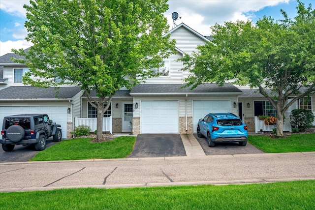8731 Quarry Ridge Ln Unit B, Woodbury, MN 55125 - view of front of house featuring driveway and brick siding