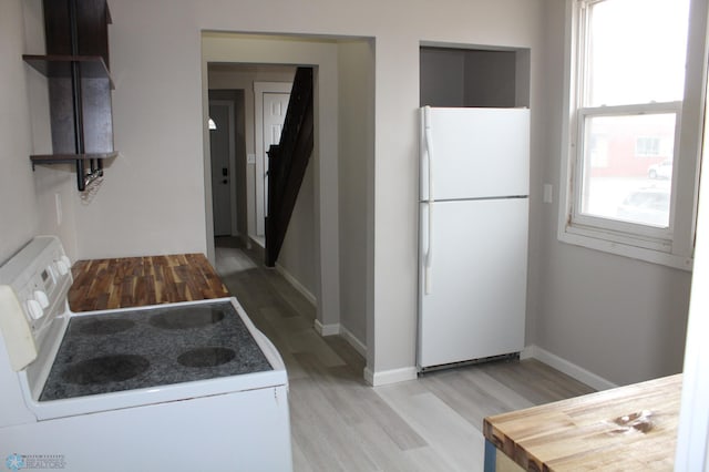 921 6th Ave N, Fargo, ND 58102 - kitchen with white appliances and light wood-style flooring