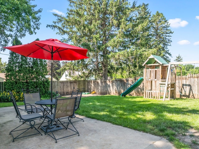 1917 2nd Ave NW, Austin, MN 55912 - fenced backyard featuring a playground and a patio area