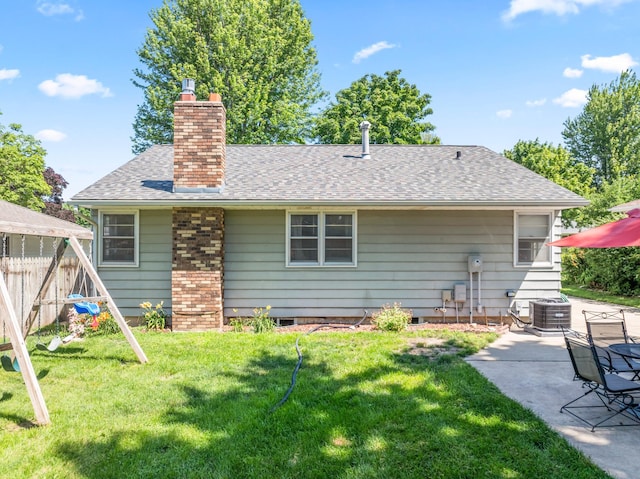 1917 2nd Ave NW, Austin, MN 55912 - rear view of property with a chimney, a patio area, and roof with shingles