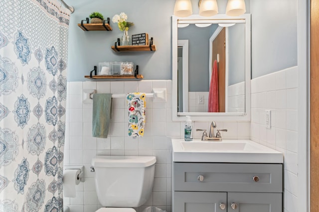 1917 2nd Ave NW, Austin, MN 55912 - bathroom featuring tile walls, vanity, curtained shower, and a wainscoted wall