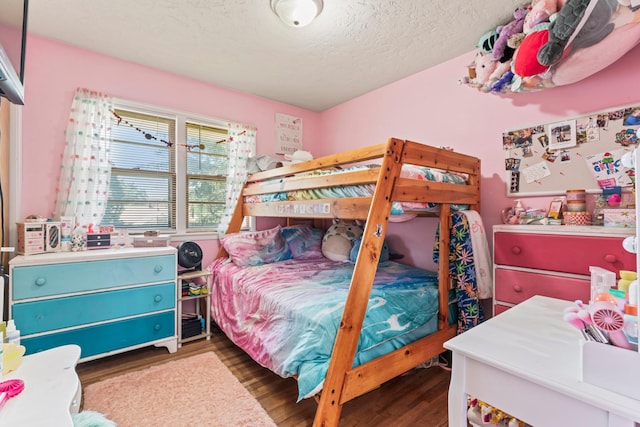 1917 2nd Ave NW, Austin, MN 55912 - bedroom featuring wood finished floors and a textured ceiling