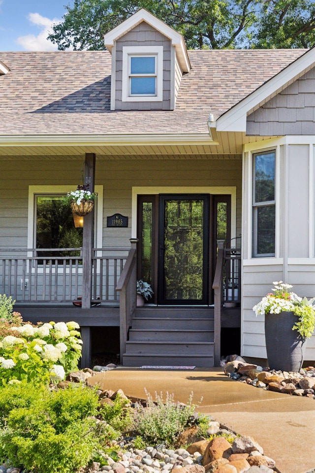 11985 Lever Ct NE, Blaine, MN 55449 - property entrance with a porch and a shingled roof
