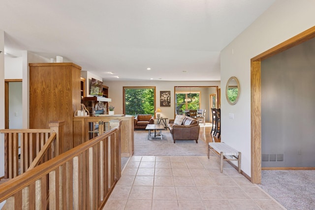 11985 Lever Ct NE, Blaine, MN 55449 - hall featuring light colored carpet, light tile patterned floors, recessed lighting, and an upstairs landing