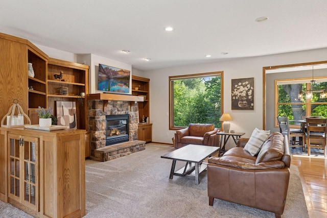 11985 Lever Ct NE, Blaine, MN 55449 - living room with healthy amount of natural light, a stone fireplace, and recessed lighting