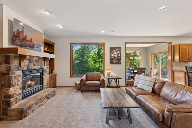 11985 Lever Ct NE, Blaine, MN 55449 - living area with plenty of natural light, a stone fireplace, light colored carpet, and recessed lighting