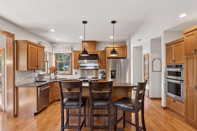11985 Lever Ct NE, Blaine, MN 55449 - kitchen with appliances with stainless steel finishes, light wood-type flooring, backsplash, dark stone countertops, and recessed lighting