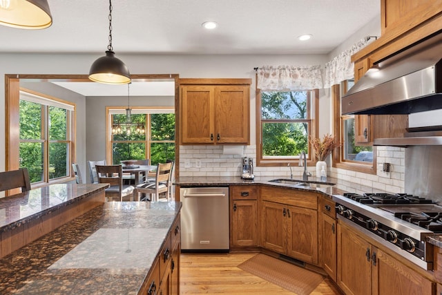 11985 Lever Ct NE, Blaine, MN 55449 - kitchen featuring stainless steel appliances, plenty of natural light, brown cabinetry, backsplash, and recessed lighting