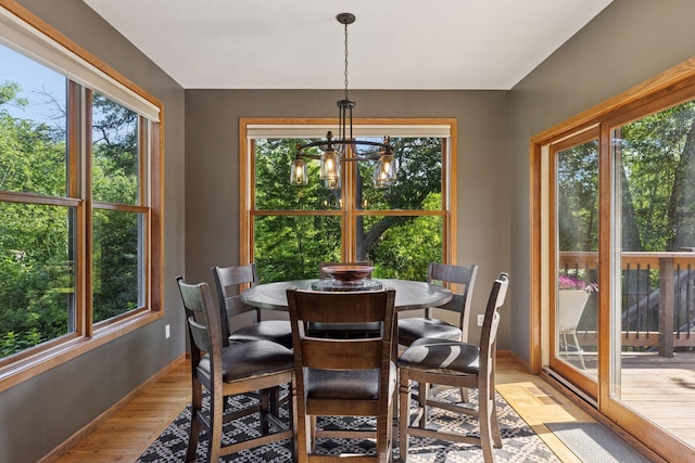 11985 Lever Ct NE, Blaine, MN 55449 - dining space featuring plenty of natural light, light wood-style flooring, and a chandelier