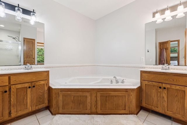 11985 Lever Ct NE, Blaine, MN 55449 - full bath with tile patterned floors, two vanities, a shower stall, and a bath