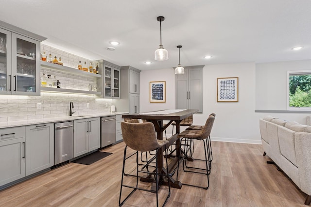 11985 Lever Ct NE, Blaine, MN 55449 - kitchen with gray cabinetry, stainless steel dishwasher, tasteful backsplash, light wood-type flooring, and recessed lighting
