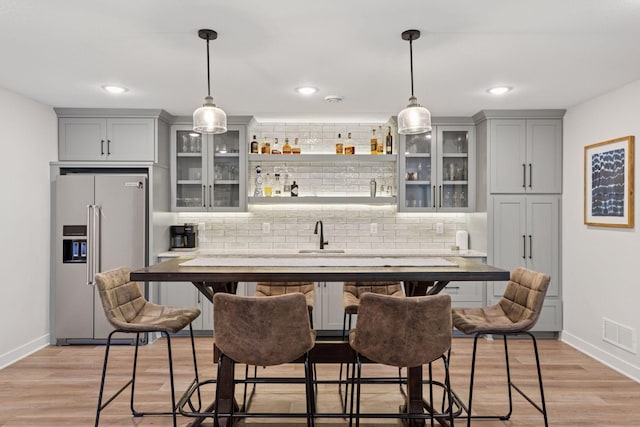 11985 Lever Ct NE, Blaine, MN 55449 - indoor wet bar featuring high quality fridge, decorative backsplash, pendant lighting, and recessed lighting
