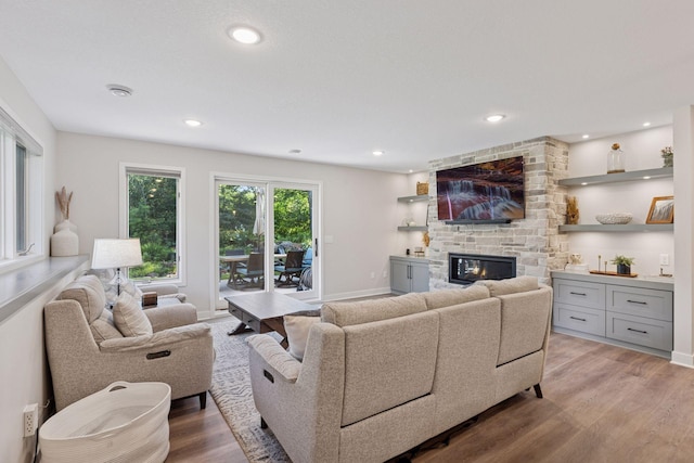 11985 Lever Ct NE, Blaine, MN 55449 - living area featuring light wood-style floors, a fireplace, and recessed lighting