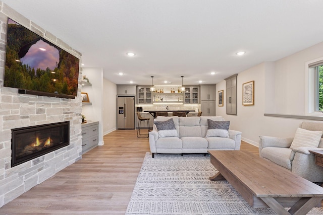 11985 Lever Ct NE, Blaine, MN 55449 - living area with a stone fireplace, recessed lighting, and light wood finished floors