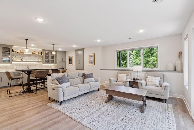 11985 Lever Ct NE, Blaine, MN 55449 - living room featuring light wood finished floors, recessed lighting, and bar