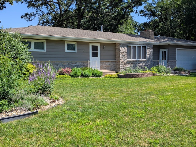 417 Ridge Rd, Albert Lea, MN 56007 - ranch-style home with a garage, a chimney, stone siding, and a front yard