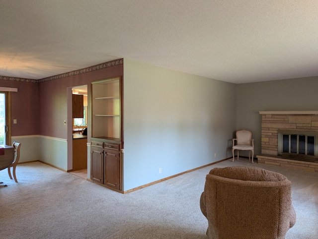 417 Ridge Rd, Albert Lea, MN 56007 - living room featuring light colored carpet, a textured ceiling, and a stone fireplace