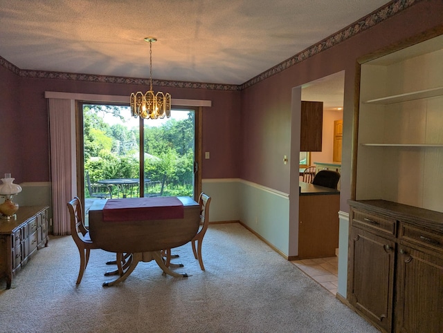 417 Ridge Rd, Albert Lea, MN 56007 - dining space featuring a chandelier, light carpet, and a textured ceiling