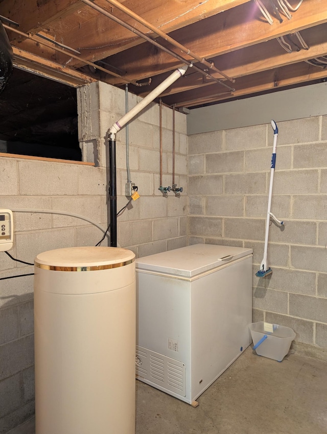 417 Ridge Rd, Albert Lea, MN 56007 - unfinished basement featuring refrigerator and a water softener system