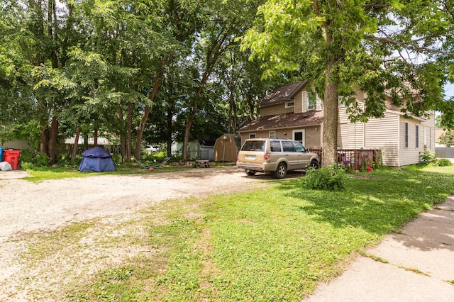 803 5th St, Winona, MN 55987 - view of home's exterior with a storage shed and a lawn