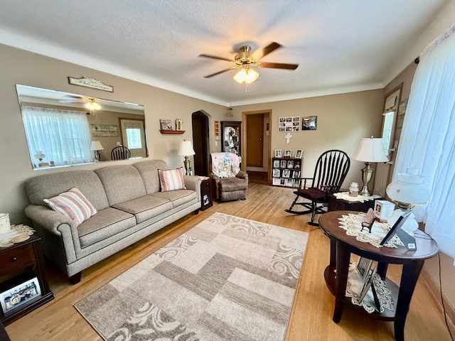 905 Clausen Ave, Albert Lea, MN 56007 - living room with ceiling fan, arched walkways, and light wood-style flooring