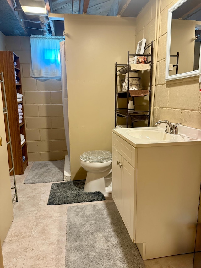 905 Clausen Ave, Albert Lea, MN 56007 - bathroom featuring concrete block wall, vanity, and a shower