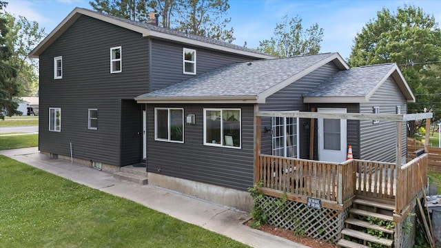 602 8th St NW, Chisholm, MN 55719 - rear view of property with roof with shingles, a deck, and a lawn