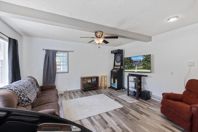 602 8th St NW, Chisholm, MN 55719 - living area with a textured ceiling, light wood-style flooring, a ceiling fan, and beam ceiling