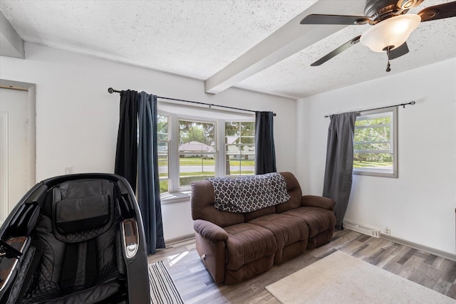 602 8th St NW, Chisholm, MN 55719 - sitting room featuring plenty of natural light, wood finished floors, a textured ceiling, beamed ceiling, and ceiling fan
