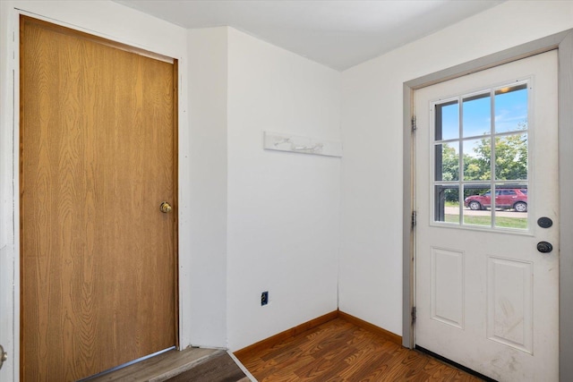 602 8th St NW, Chisholm, MN 55719 - doorway with dark wood-style floors and baseboards