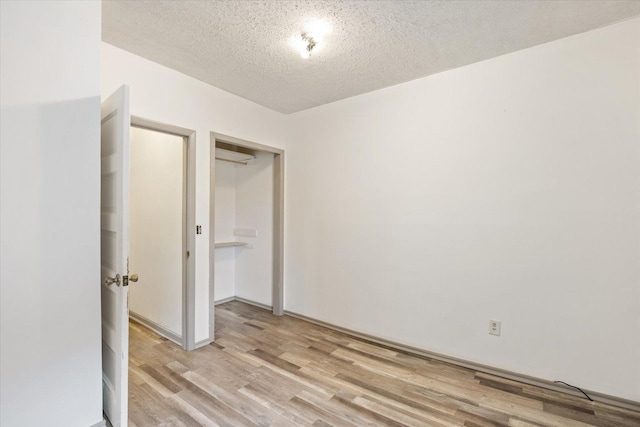 602 8th St NW, Chisholm, MN 55719 - unfurnished room with light wood-style flooring and a textured ceiling