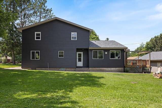 602 8th St NW, Chisholm, MN 55719 - back of property featuring a deck, a yard, and a shingled roof