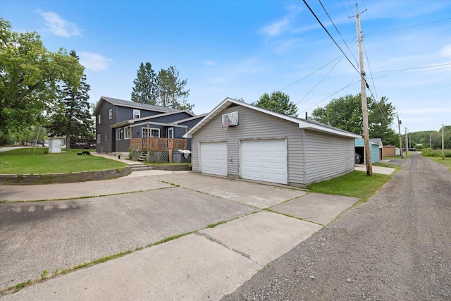 602 8th St NW, Chisholm, MN 55719 - view of front of house featuring an outbuilding, a front lawn, a garage, and a deck