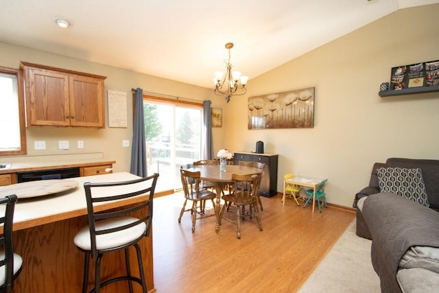 2223 Fairbanks Dr, North Mankato, MN 56003 - dining area with a chandelier, light wood finished floors, and lofted ceiling