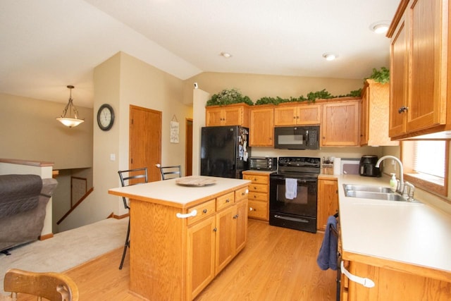 2223 Fairbanks Dr, North Mankato, MN 56003 - kitchen with black appliances, light wood-style flooring, vaulted ceiling, light countertops, and a breakfast bar