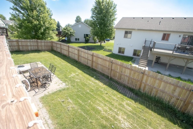 2223 Fairbanks Dr, North Mankato, MN 56003 - fenced backyard with stairway, a deck, a patio, and outdoor dining area