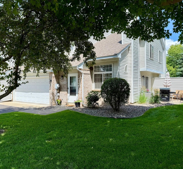 8744 Bechtel Ave Unit 109, Inver Grove Heights, MN 55076 - view of front of home featuring a front yard, a shingled roof, a garage, and driveway