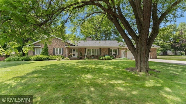 950 Tuva Rd SE, Cokato, MN 55321 - ranch-style home with a front yard, brick siding, a chimney, and concrete driveway