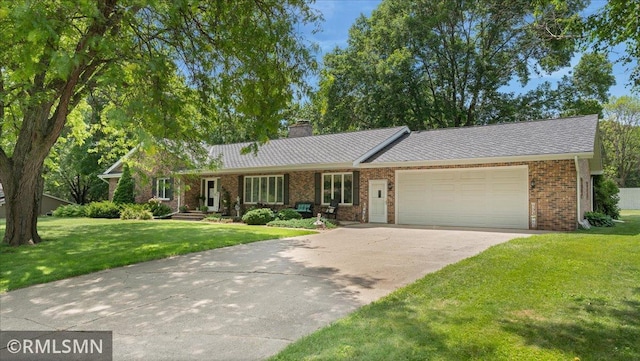 950 Tuva Rd SE, Cokato, MN 55321 - single story home featuring a garage, a front lawn, driveway, a chimney, and brick siding