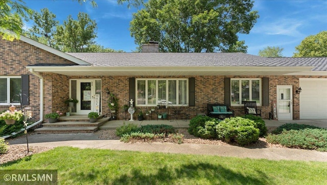 950 Tuva Rd SE, Cokato, MN 55321 - view of front of property featuring a garage, brick siding, and a chimney
