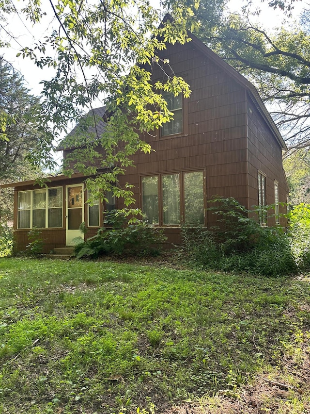 16140 Central Ave NE, Ham Lake, MN 55304 - view of front of house with a sunroom and a front lawn